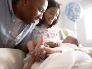 Lactation consultant providing support to new mother and her baby in a warm, caring environment.